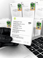 20W USB-C Power Adapters in white retail packaging next to a laptop keyboard.