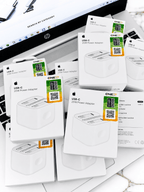 Multiple white boxes of USB-C 20W Power Adapters arranged on a white surface.