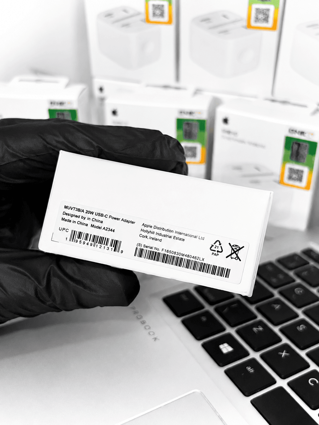 Close-up of a 20W USB-C Power Adapter box label with serial number and barcode.