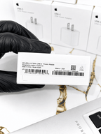 Close-up of an Apple 20W USB-C Power Adapter box showing serial number and UPC code.