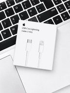 Apple USB-C to Lightning Cable 1.5m packaging resting on a laptop keyboard