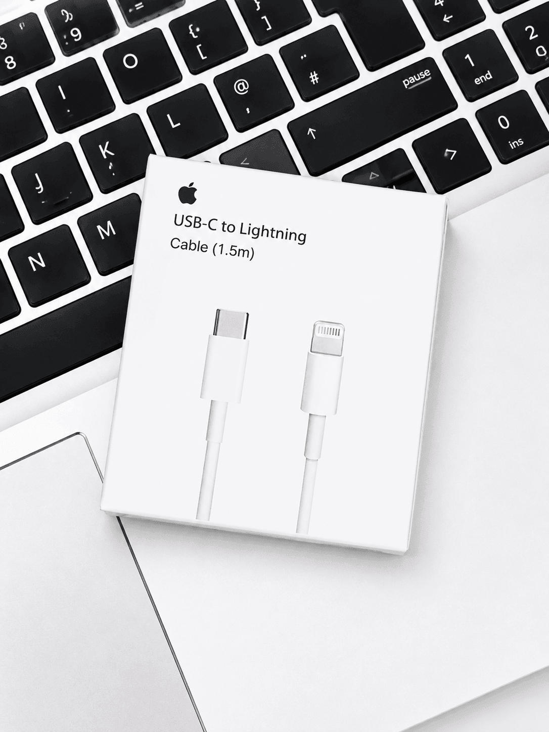 Apple USB-C to Lightning Cable 1.5m packaging resting on a laptop keyboard
