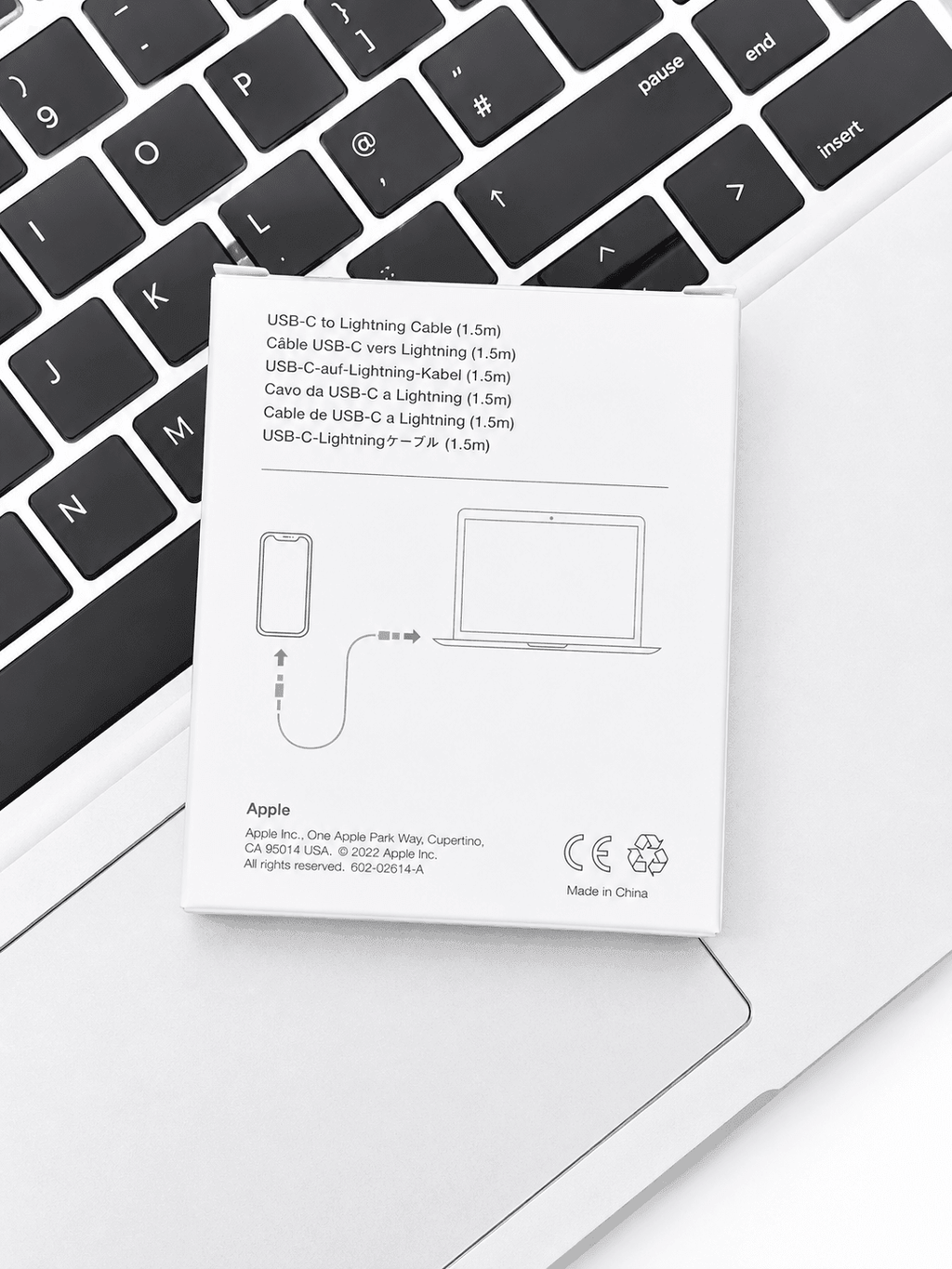 Apple USB-C to Lightning Cable packaging resting on a laptop keyboard