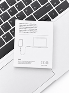 Apple USB-C to Lightning Cable packaging resting on a laptop keyboard