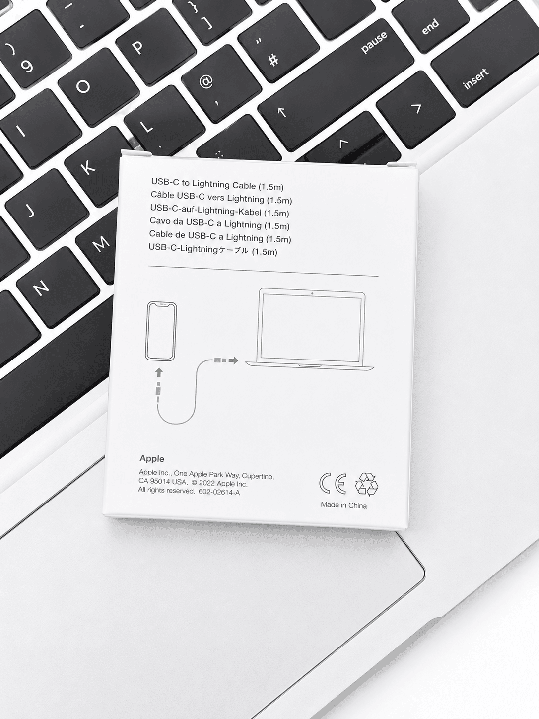 Apple USB-C to Lightning Cable packaging resting on a laptop keyboard